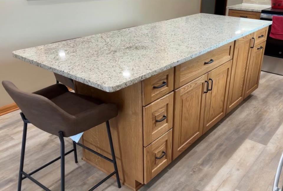 A close view of a natural oak kitchen island with stacked drawers