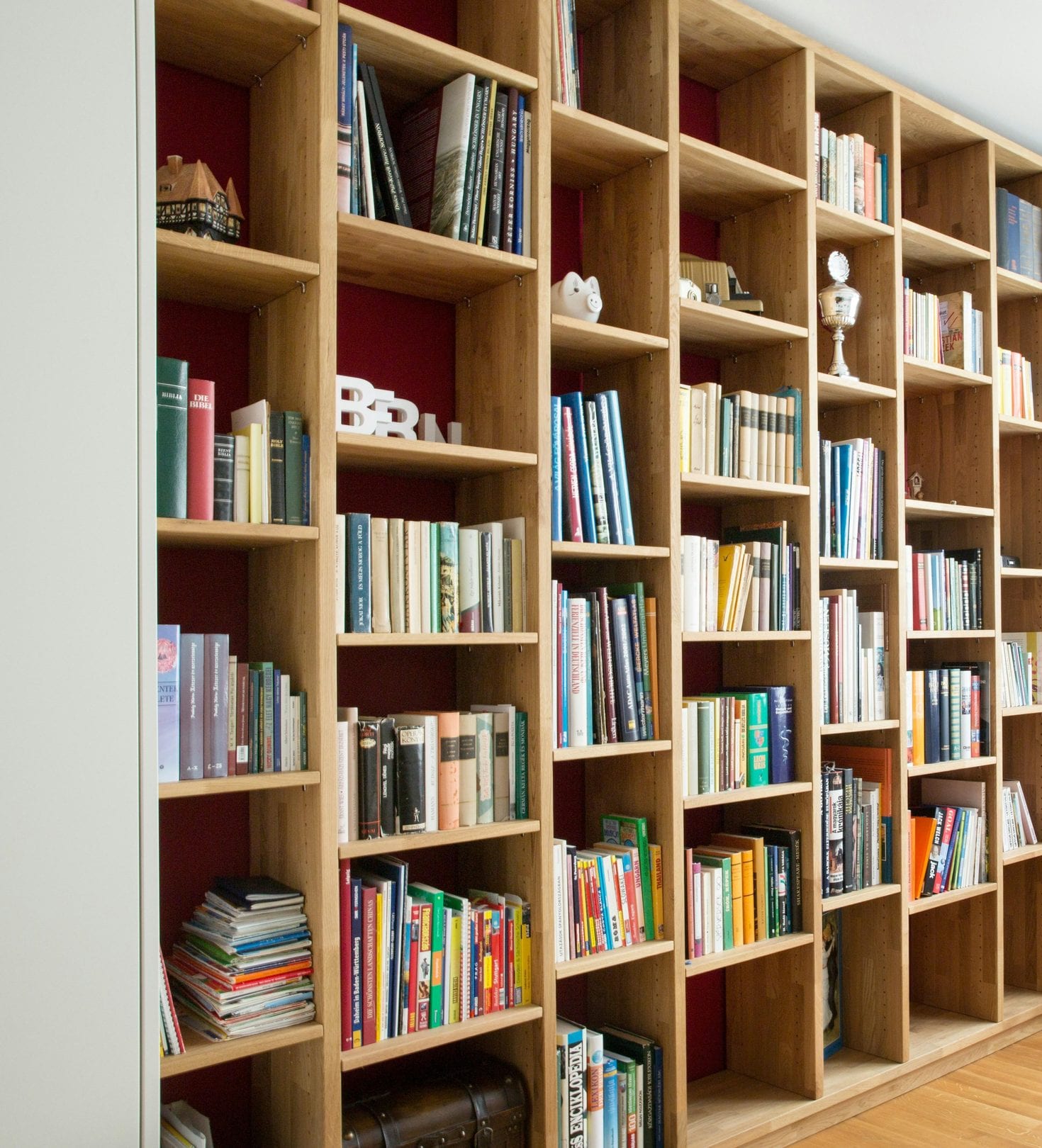 Built-in honey-oak bookshelves filling a wall, filled with books